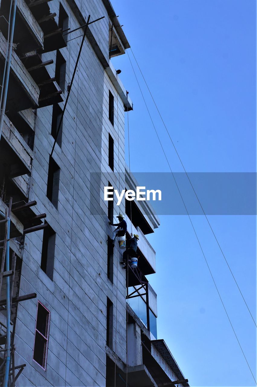 LOW ANGLE VIEW OF CABLES AGAINST BLUE SKY