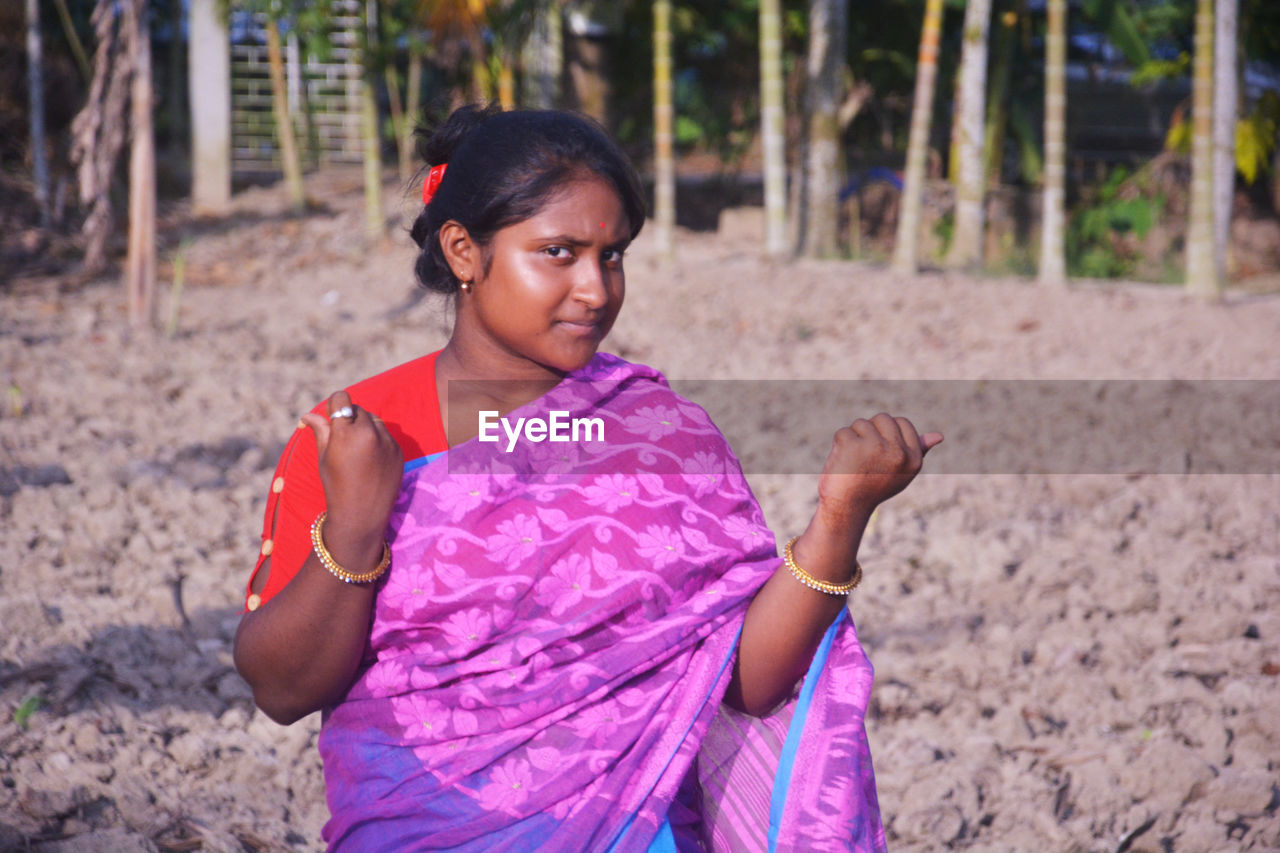 Girl looking away while standing on land