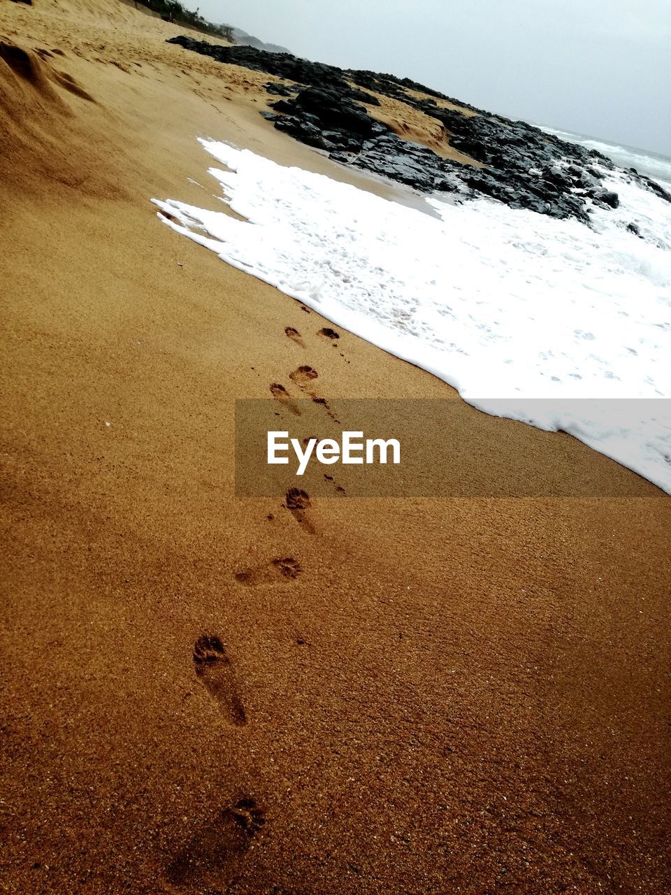 FOOTPRINTS ON BEACH