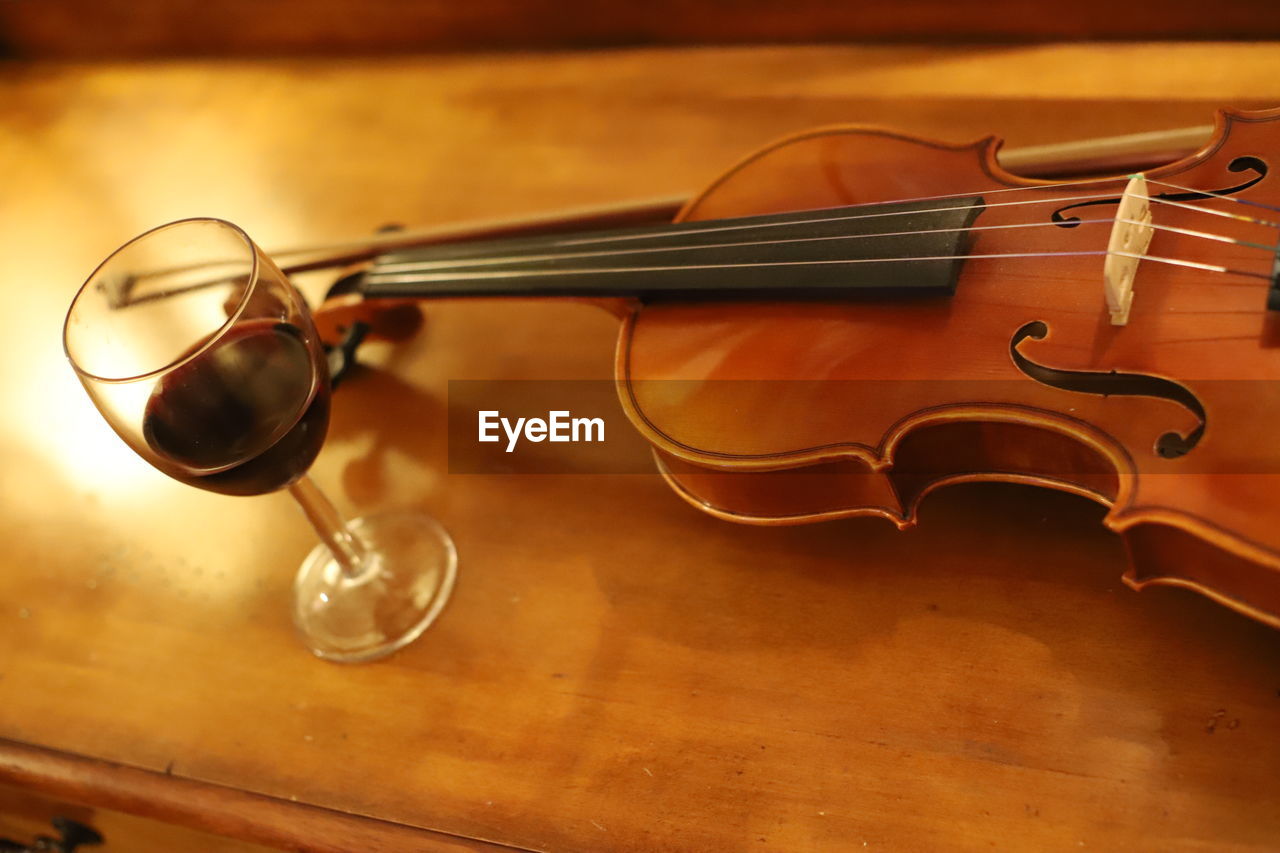 High angle view of wineglass with violin