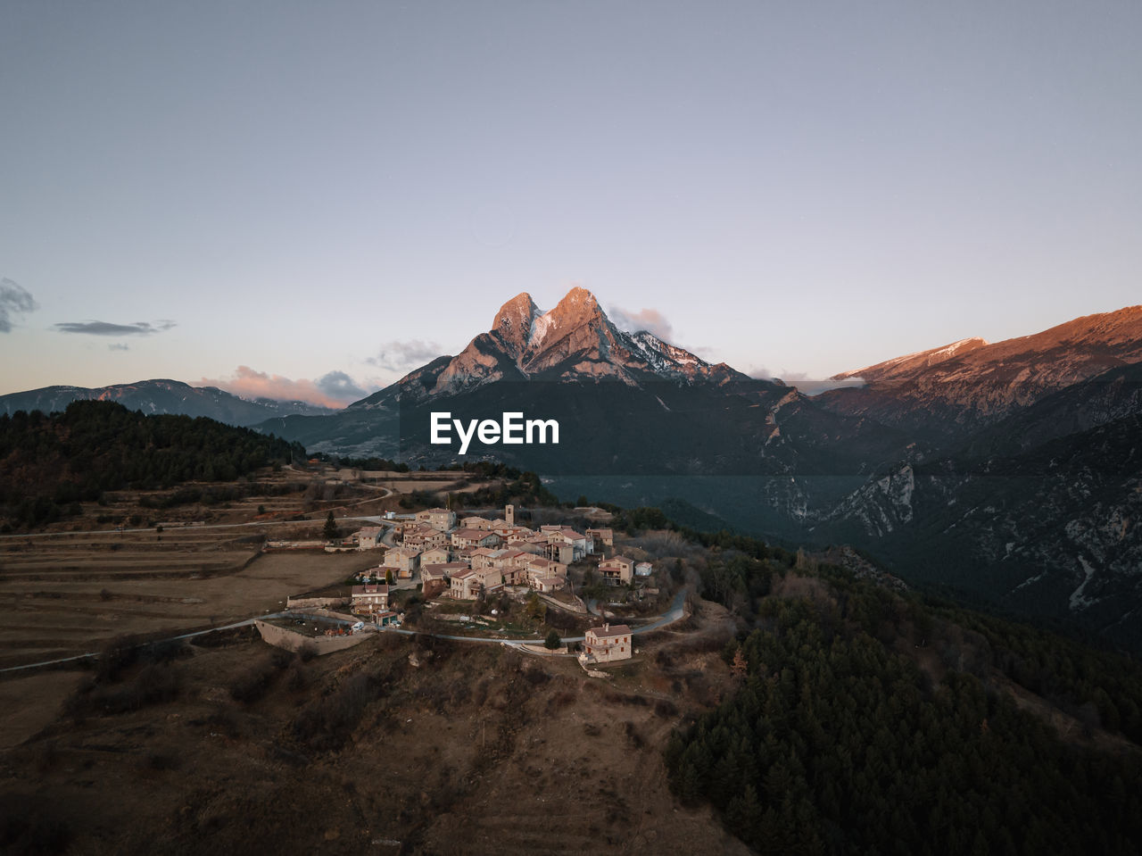 High angle view of village against snowcapped mountain range