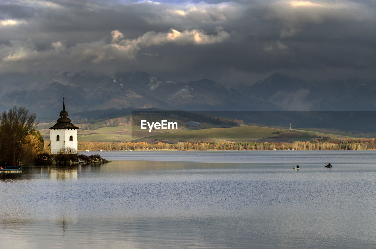 Scenic view of lake against cloudy sky