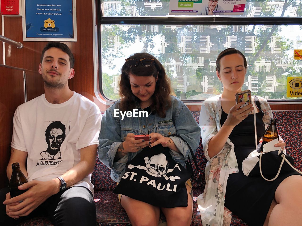 YOUNG COUPLE LOOKING AT FRIENDS SITTING IN A BUILDING