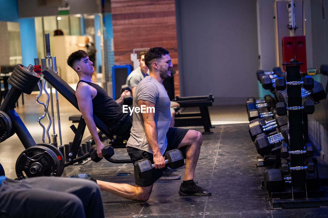 Side view of man working out at the gym