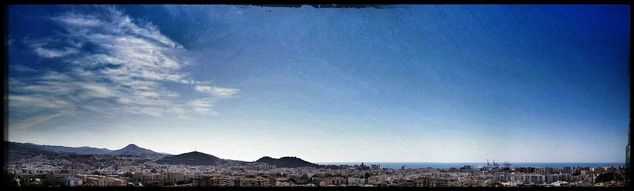 VIEW OF CITYSCAPE AGAINST BLUE SKY