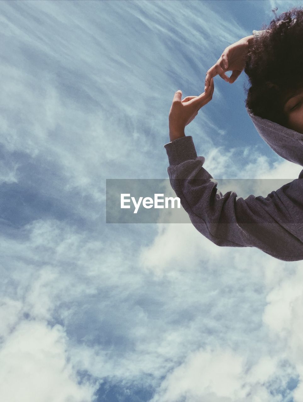 PORTRAIT OF YOUNG MAN AGAINST SKY