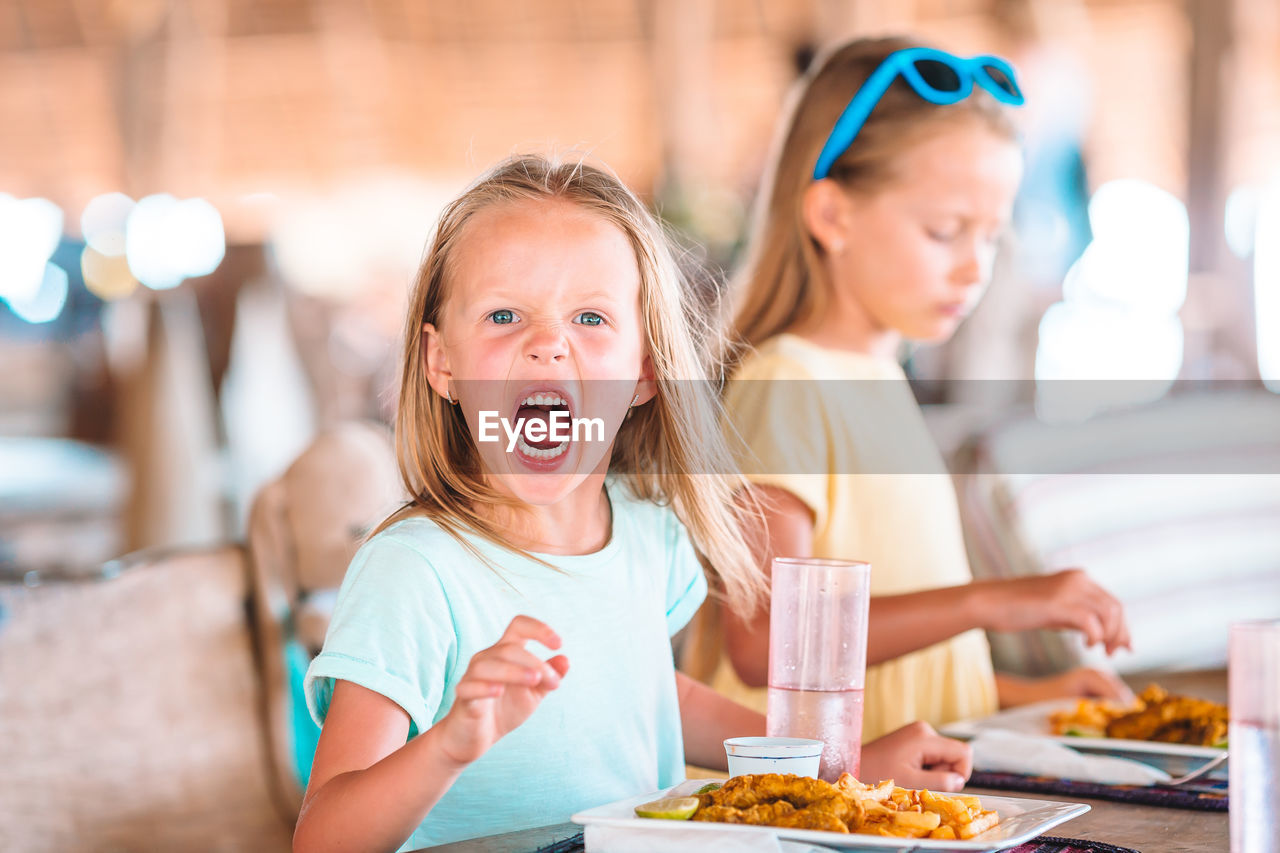 Happy girl sitting in restaurant