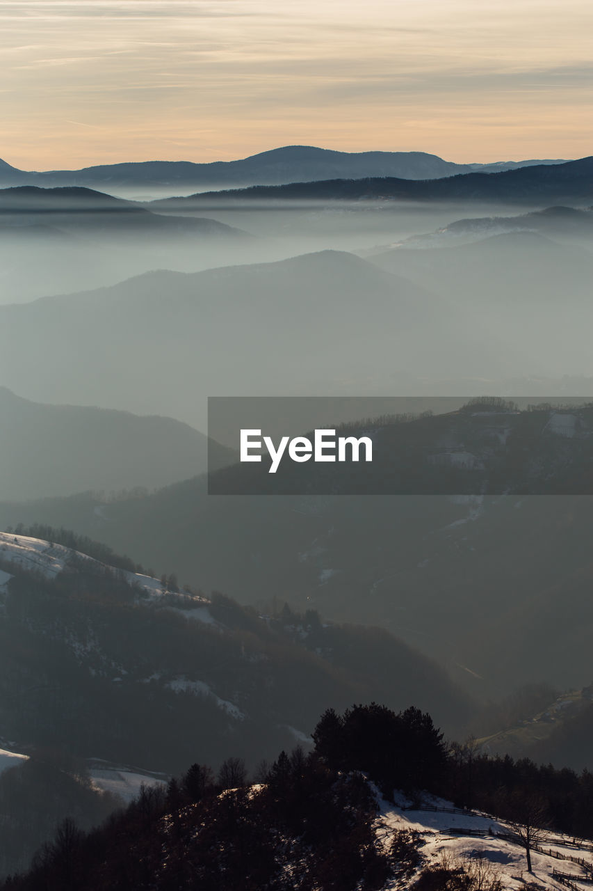 Scenic view of mountains against sky during sunset