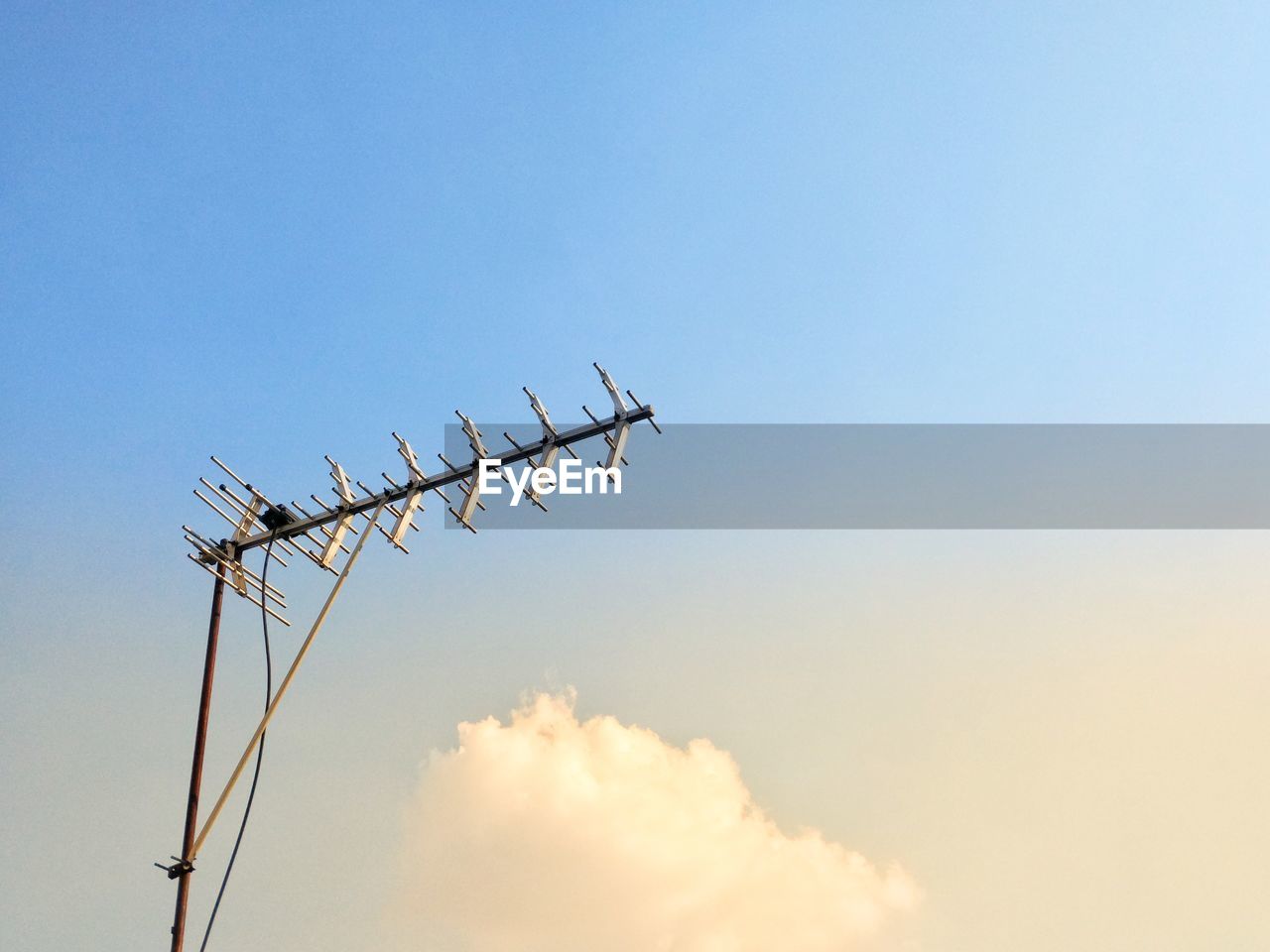 Low angle view of telephone pole against sky during sunset