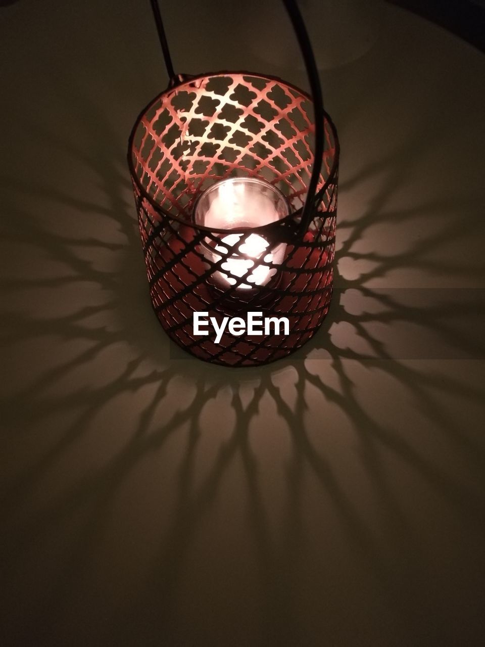 CLOSE-UP OF ILLUMINATED METAL HANGING