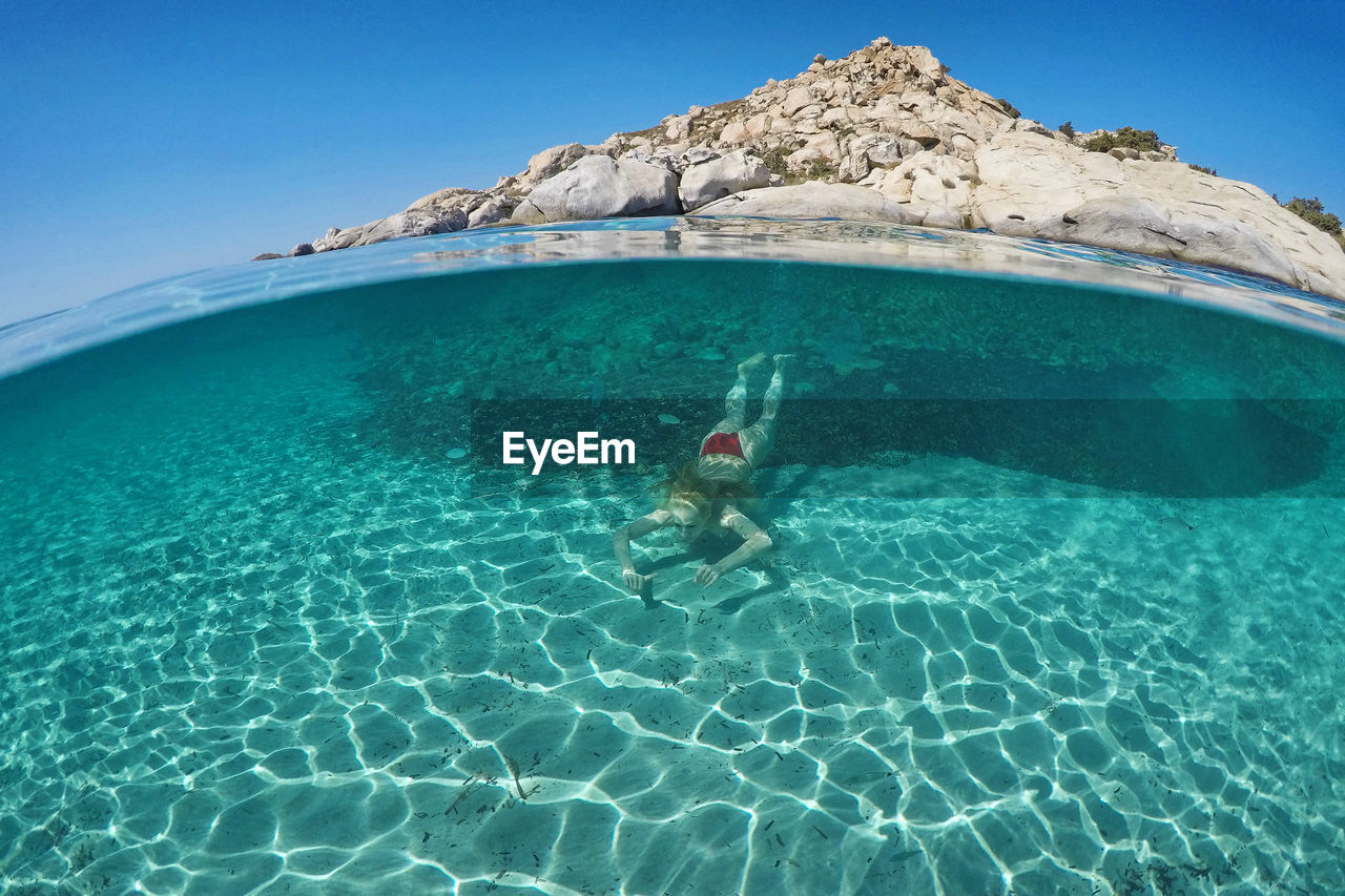 High angle view of woman swimming in sea