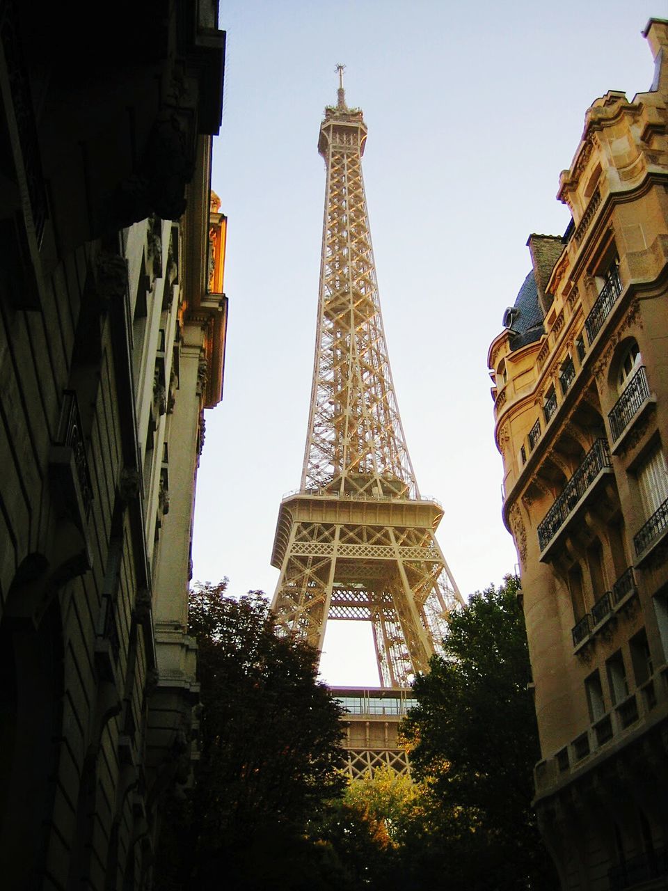 LOW ANGLE VIEW OF EIFFEL TOWER WITH EIFFEL TOWER IN BACKGROUND