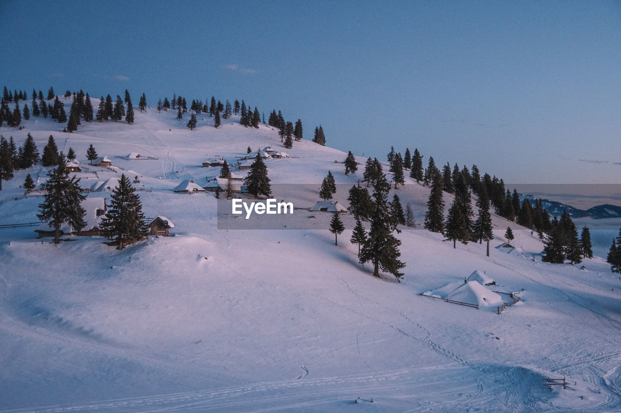 scenic view of snow covered landscape against clear blue sky