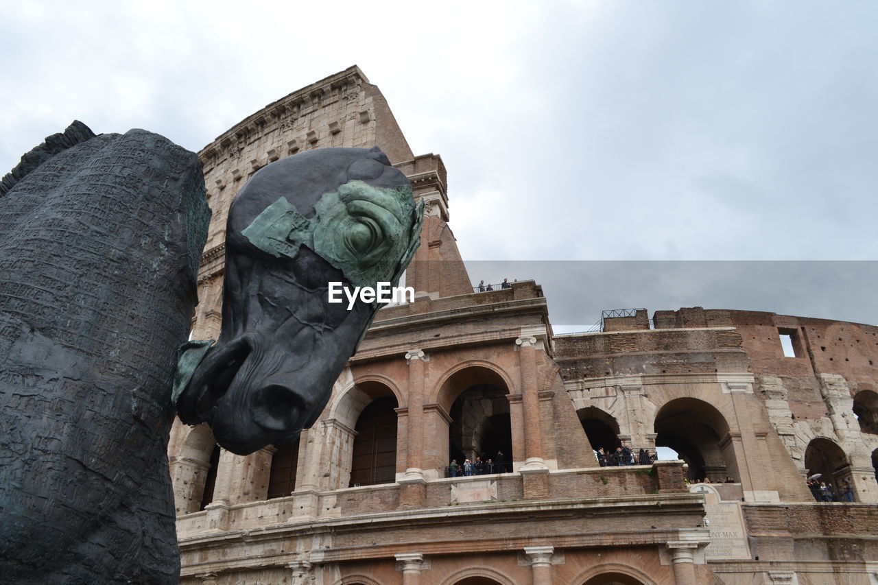 Low angle view of statue against cloudy sky