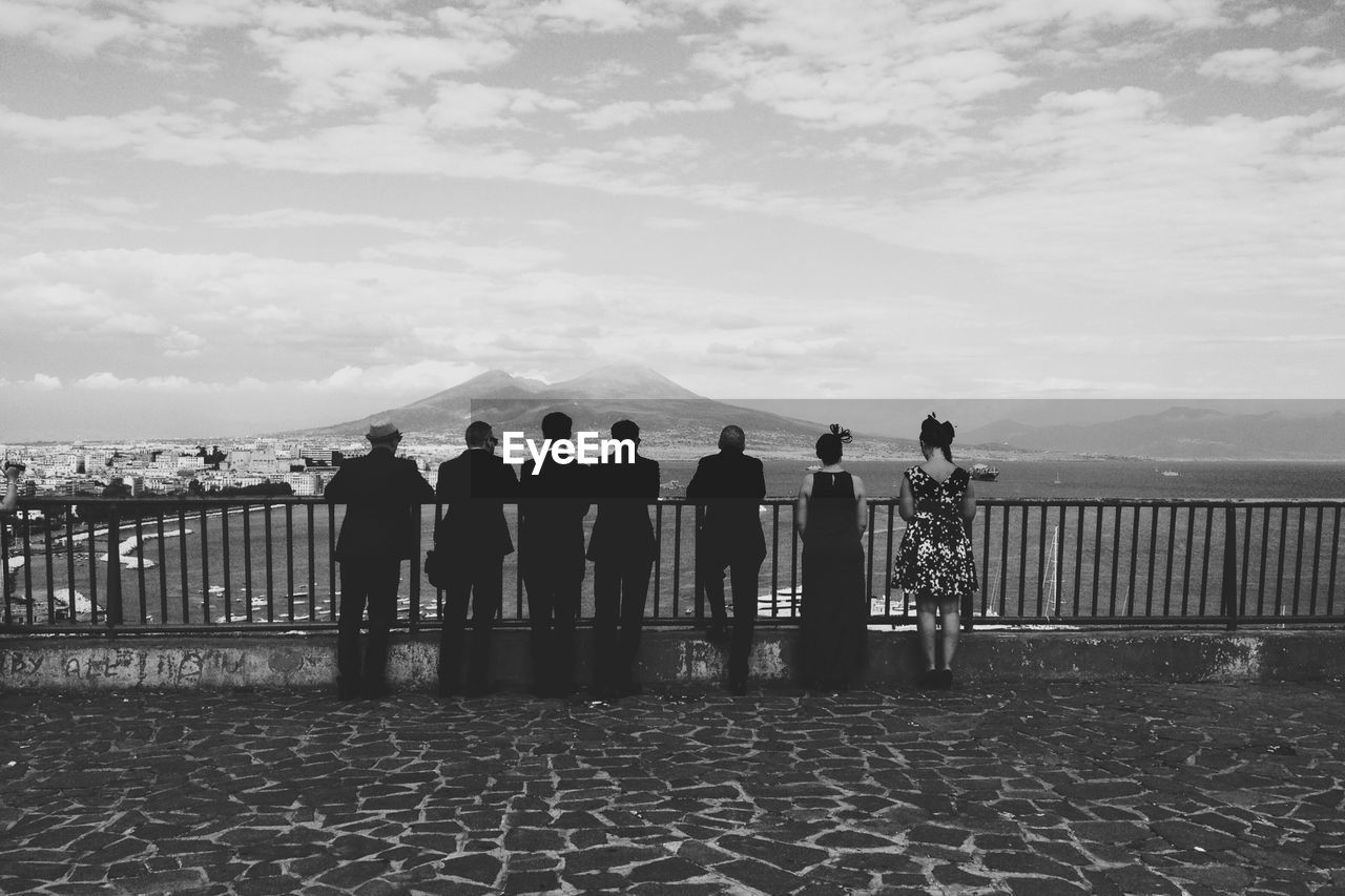 Tourists standing an observation point looking at a view