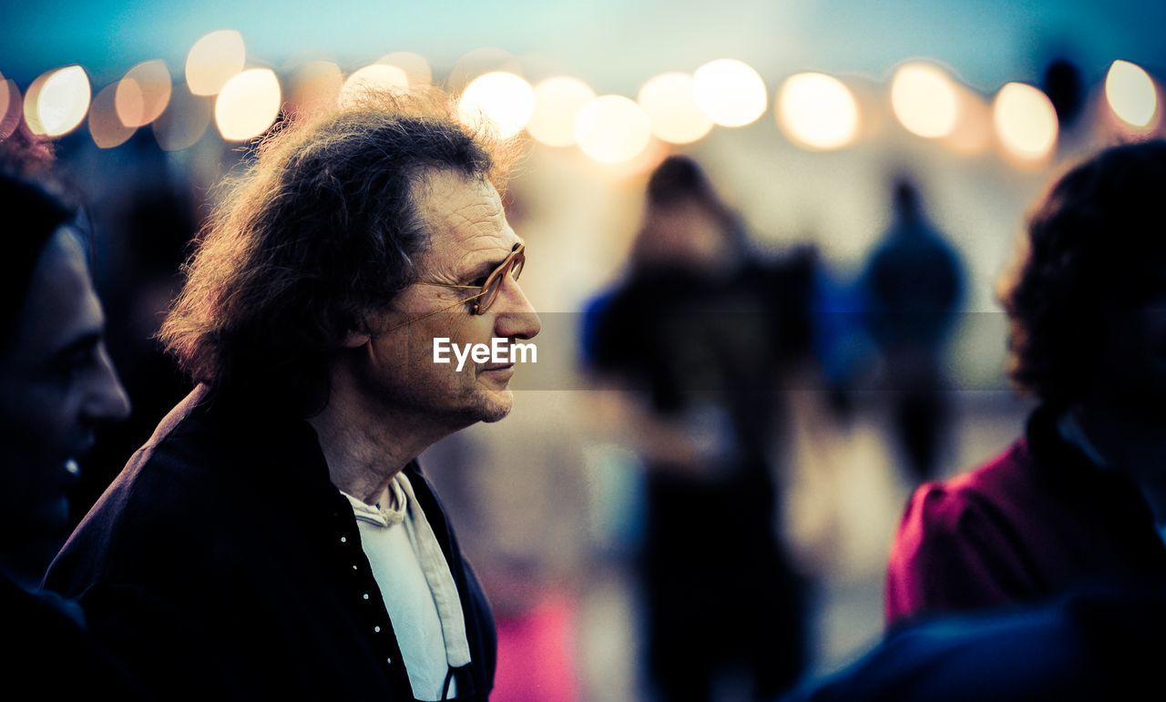 Close-up of mature men in concert at dusk