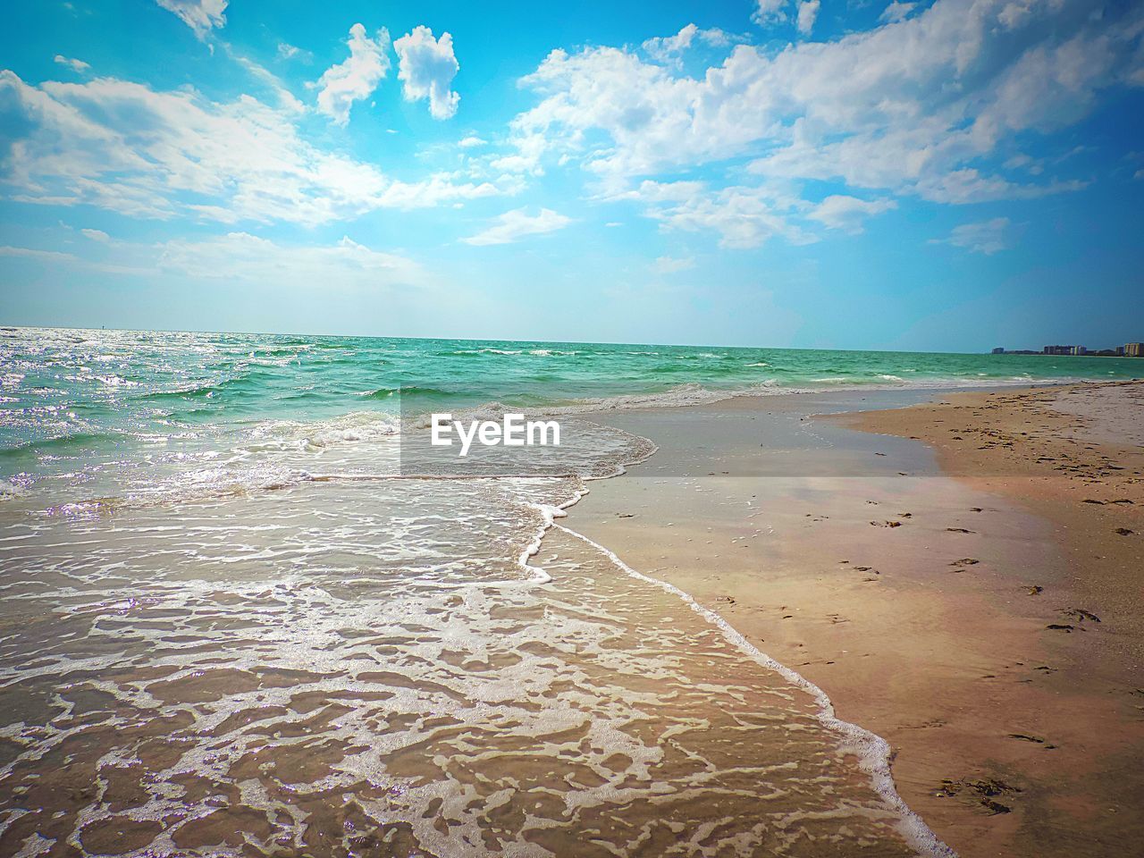 View of beach against cloudy sky