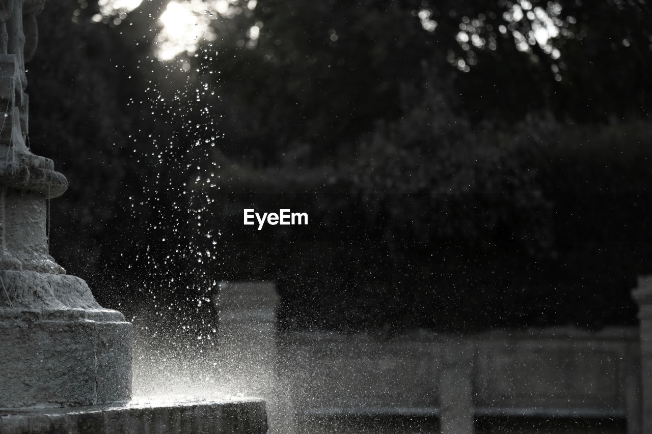 Water falling from fountain in park