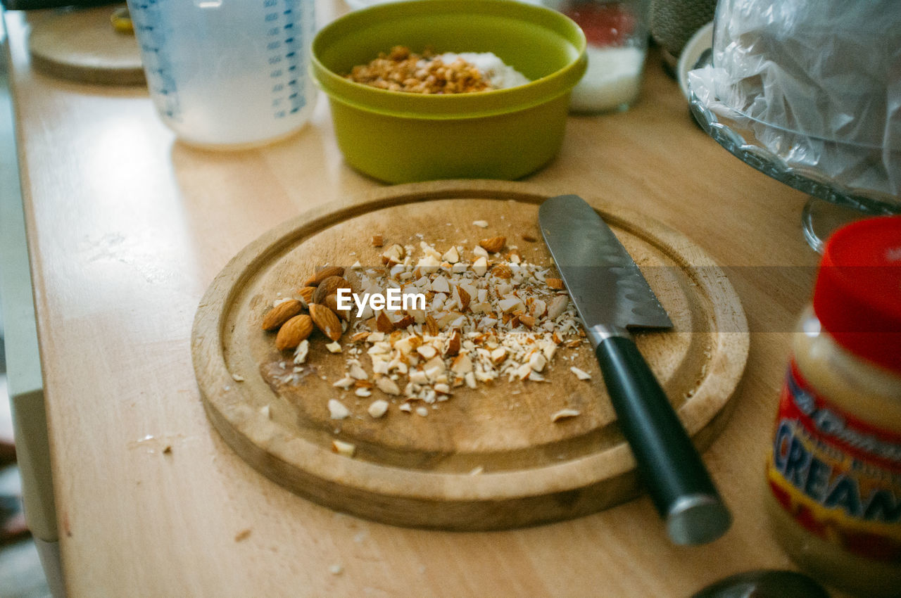 High angle view of almonds and knife on kitchen counter at home