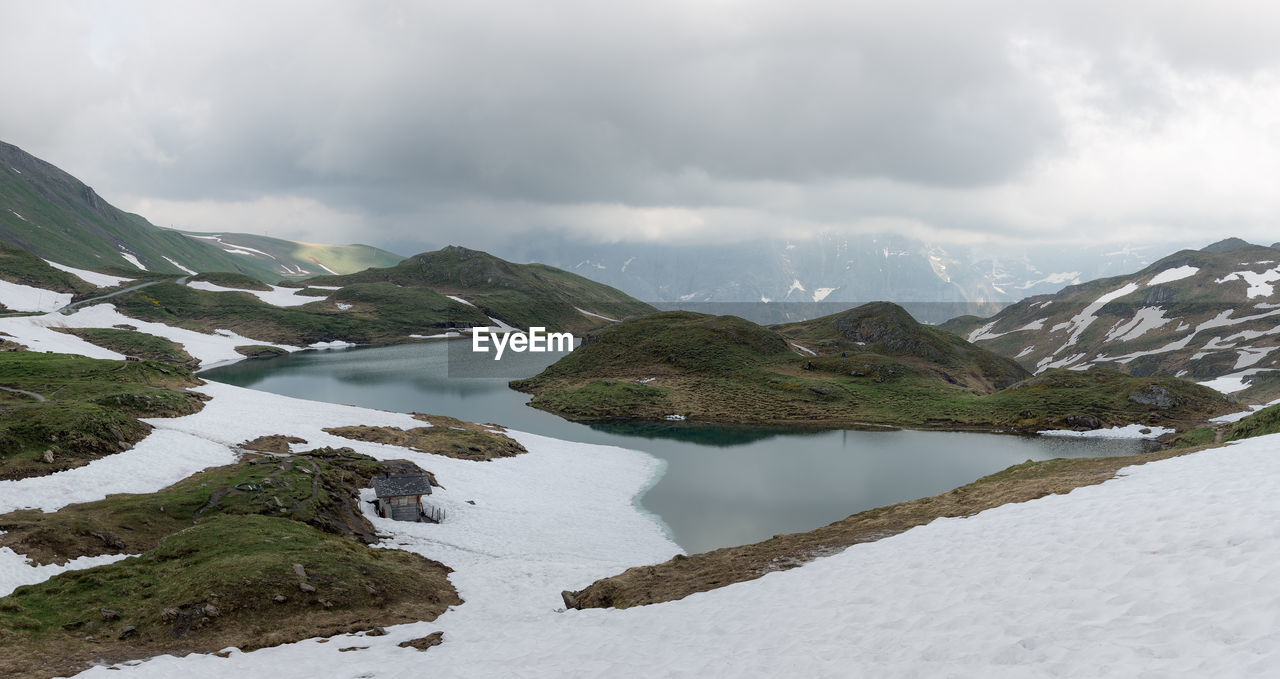 Scenic view of lake and mountains against sky