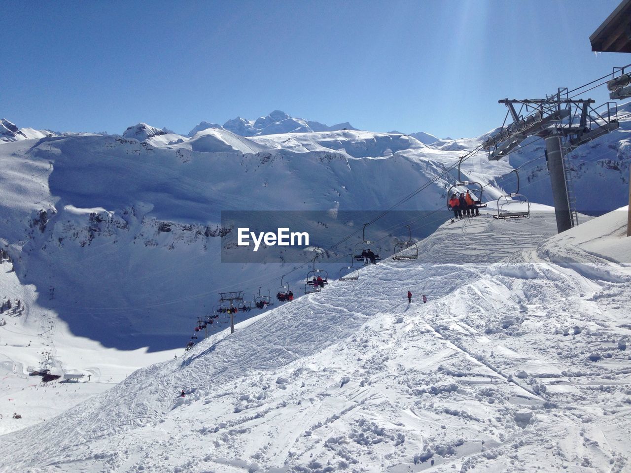 Overhead cable car on snowcapped mountains against sky