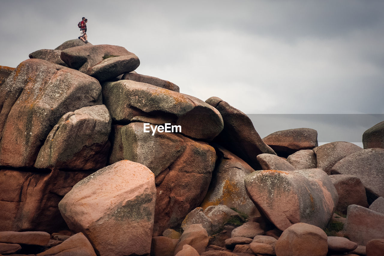 STACK OF STONES ON ROCKS AGAINST SKY