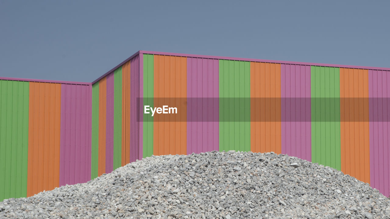 Close-up of multi colored cargo container against clear sky
