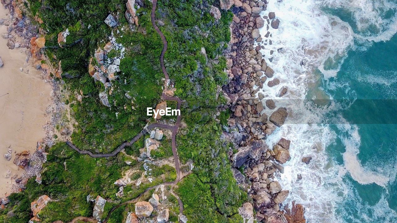 High angle view of boardwalk and rocks on beach