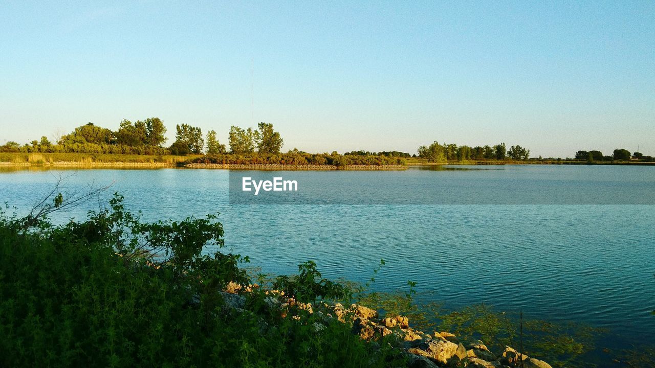 Scenic view of lake at maumee bay state park against sky during sunset