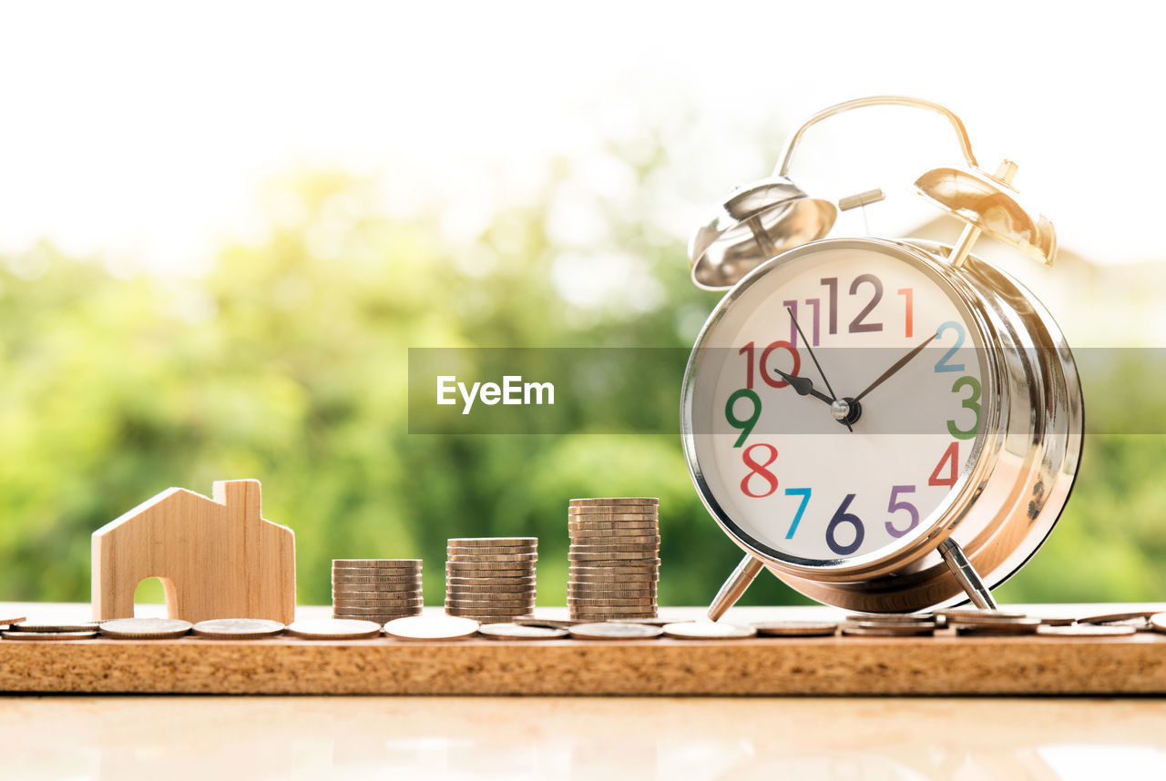 CLOSE-UP OF CLOCK ON TABLE AT HOME