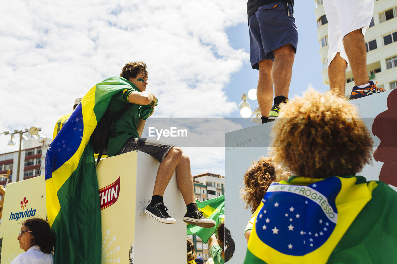 PEOPLE STANDING ON TOP OF RAILING