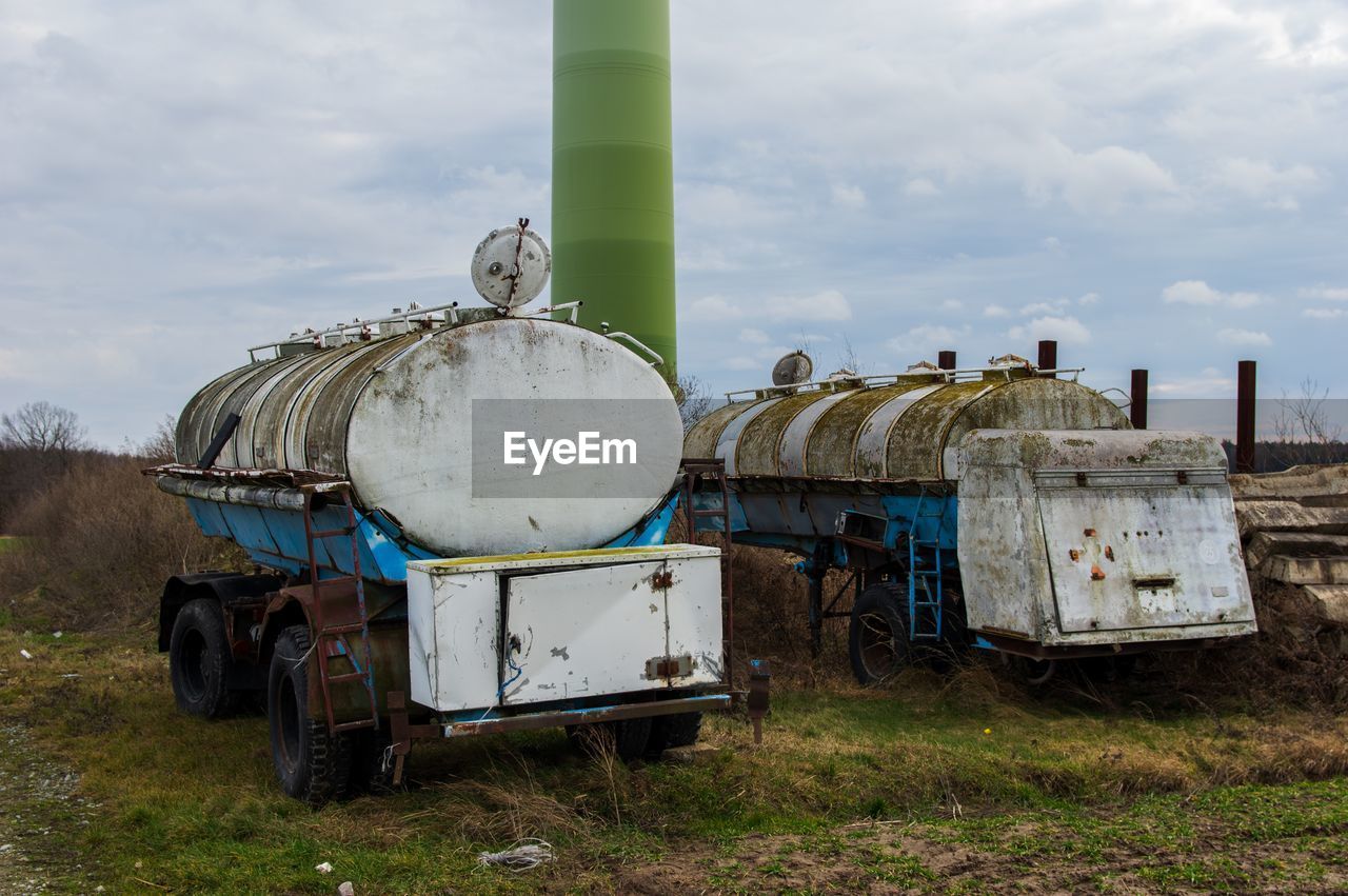 Abandoned truck on field against sky