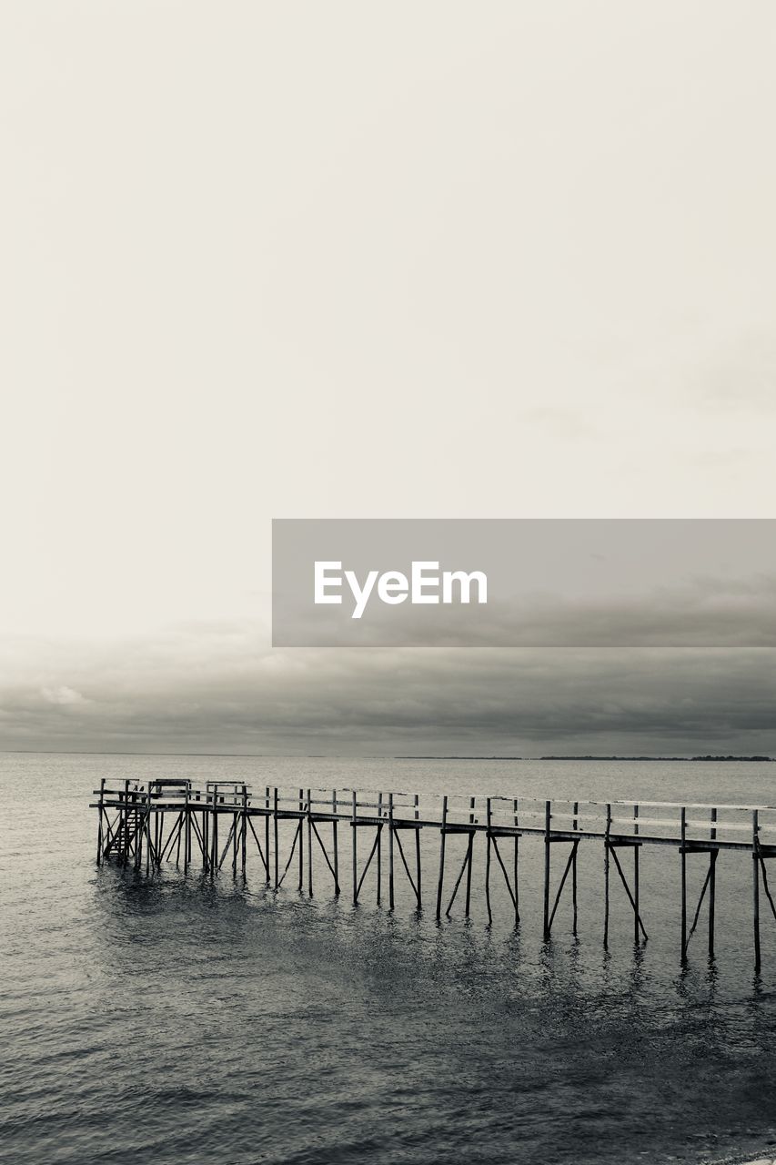 Pier over sea against sky