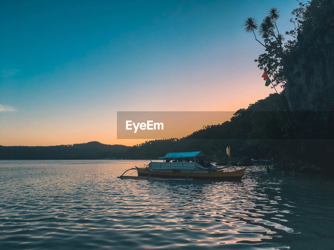 Scenic view of lake against sky during sunset