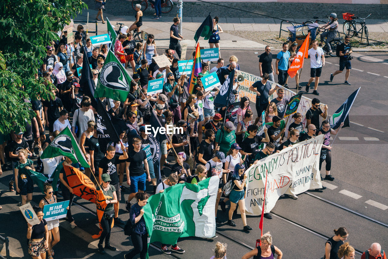 High angle view of people protesting on street in city