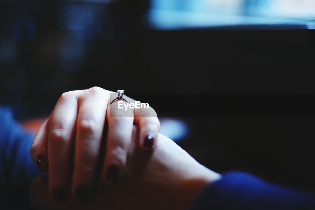 Close-up of cropped couple hands