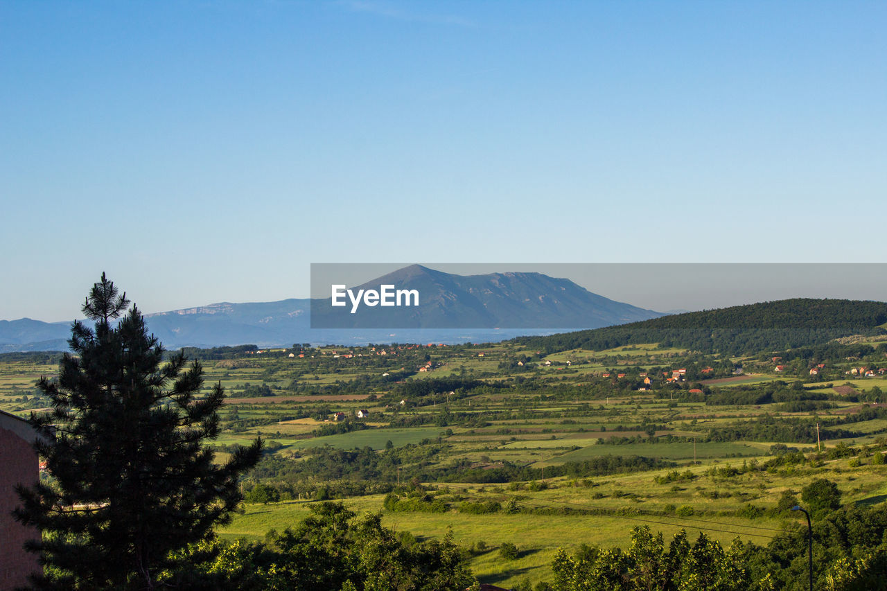 Scenic view of mountains against clear blue sky