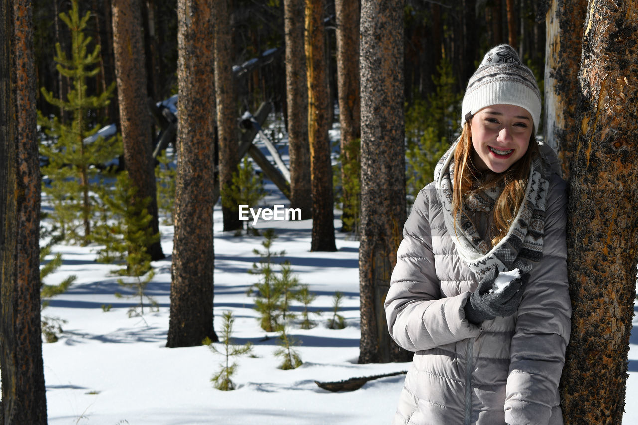 PORTRAIT OF SMILING WOMAN IN SNOW