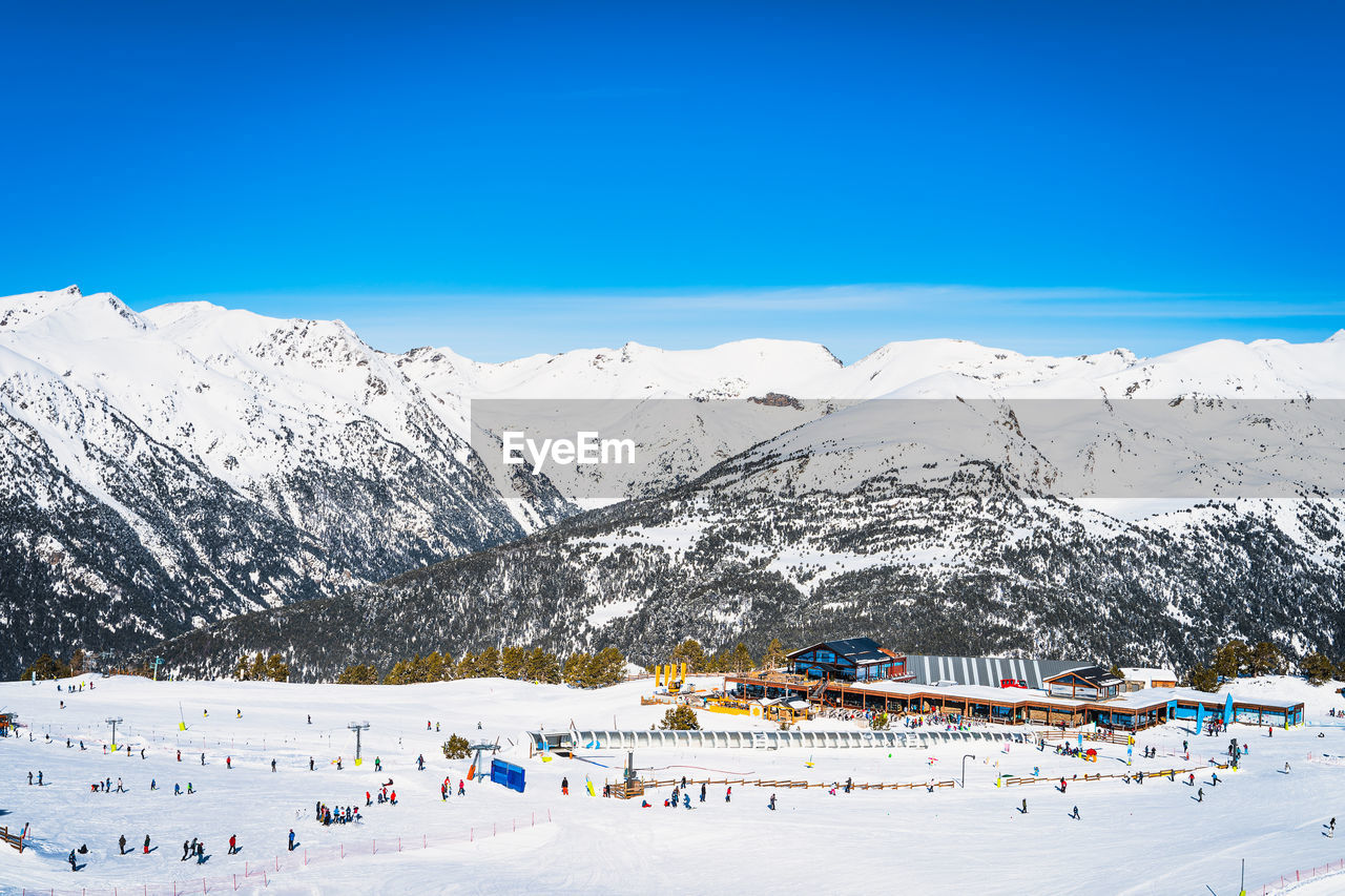 People, families, skiers and snowboarders relaxing and having fun in winter at soldeu, andorra