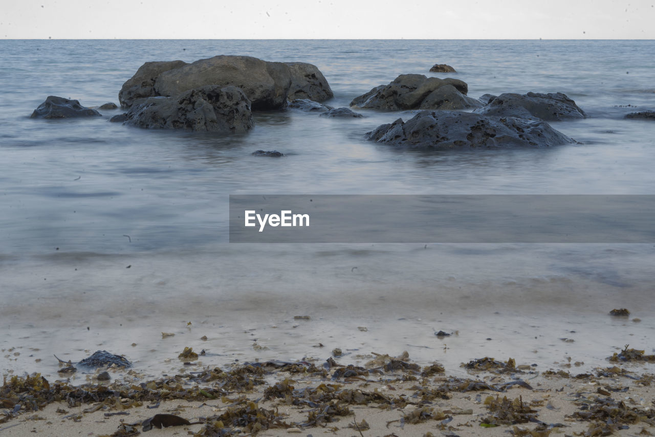 ROCKS ON SHORE AGAINST SEA