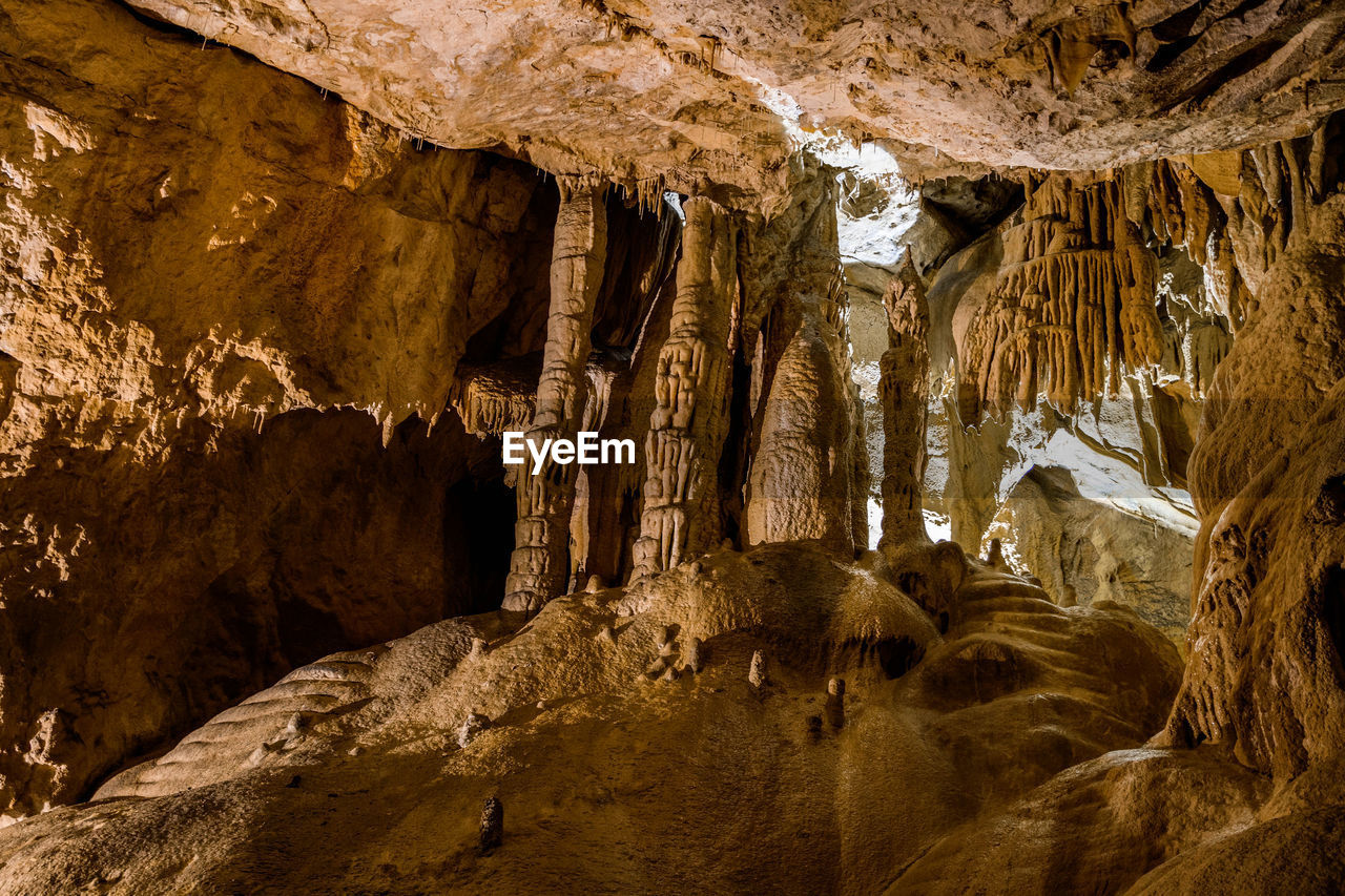 LOW ANGLE VIEW OF ROCK FORMATIONS IN CAVE