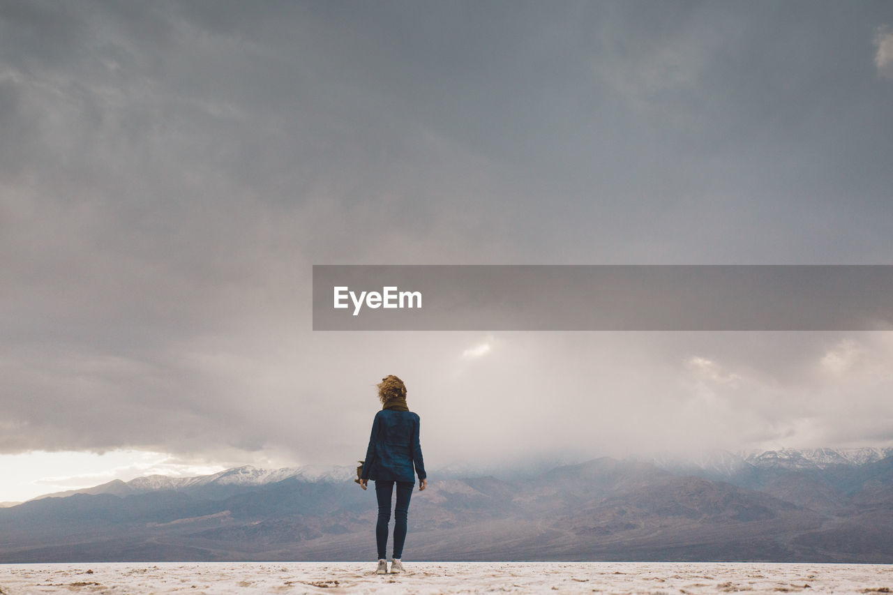 Full length of woman standing against sky