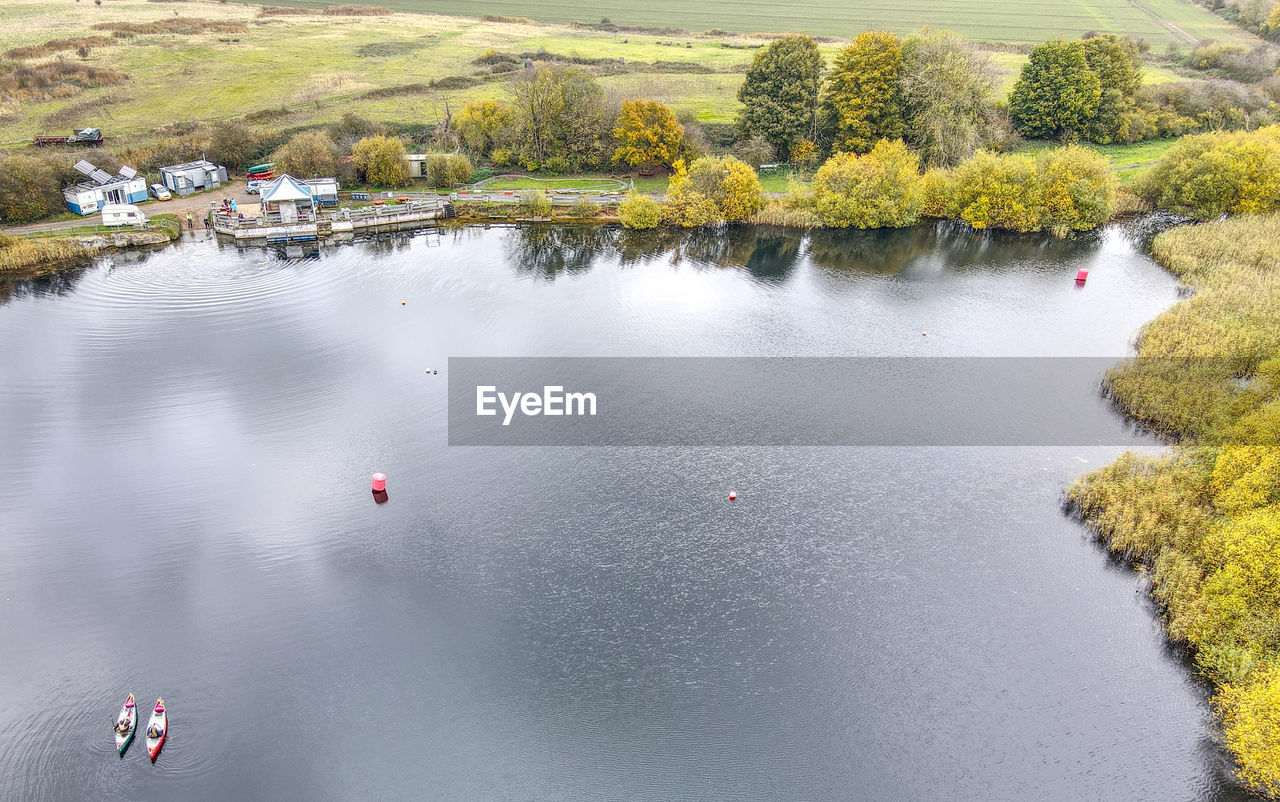 HIGH ANGLE VIEW OF LAKE AMIDST TREES