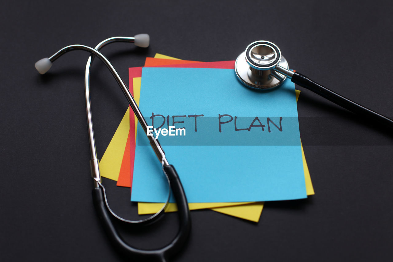 High angle view of adhesive note with message and stethoscope on table