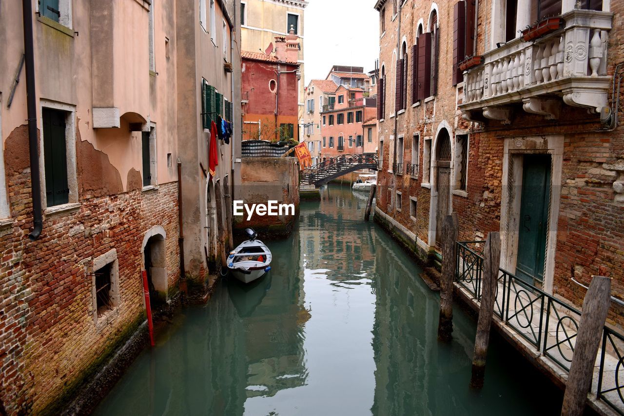 Canal amidst buildings in city