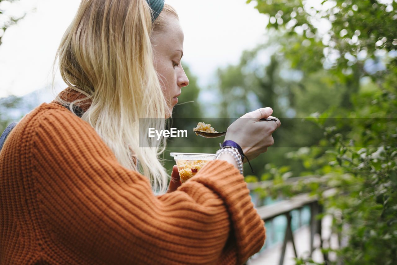 Woman eating outside