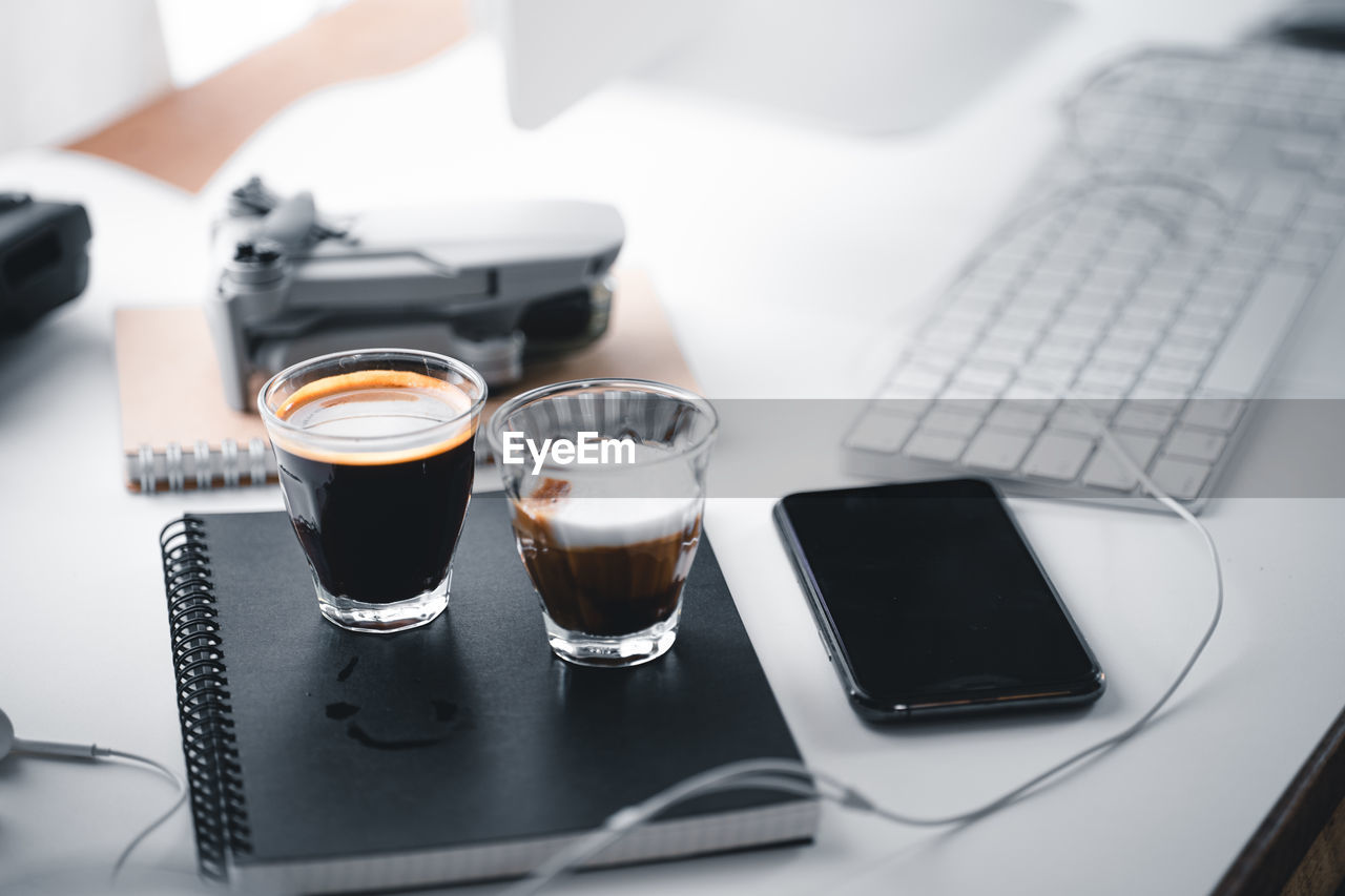 HIGH ANGLE VIEW OF COFFEE SERVED ON TABLE AT HOME