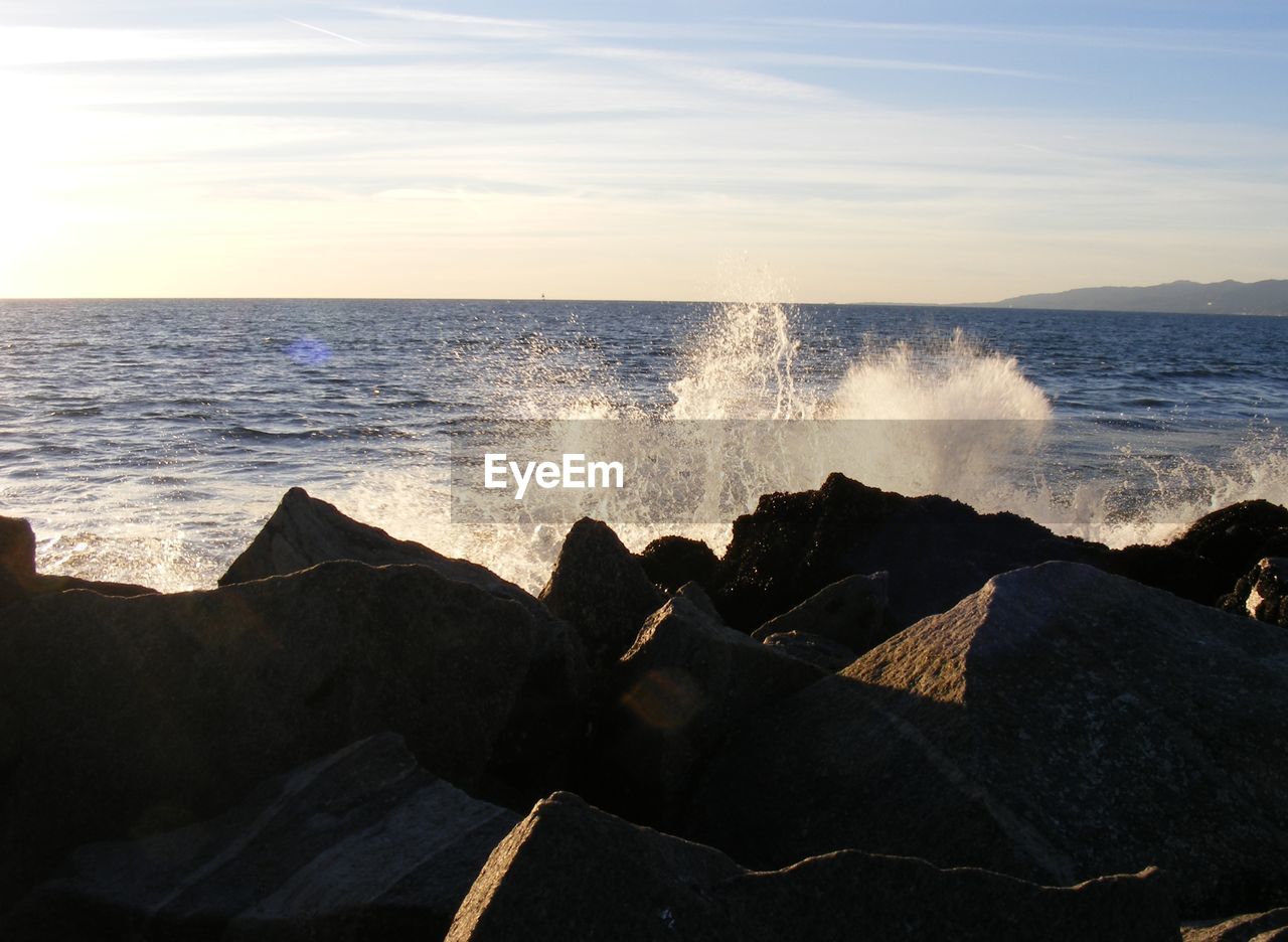 Waves breaking on rocks on beach