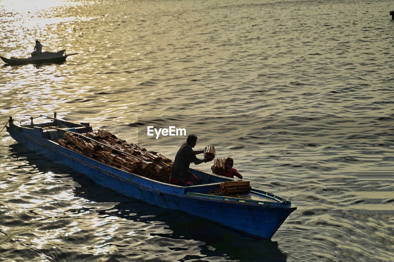 Fisherman in boat on sea