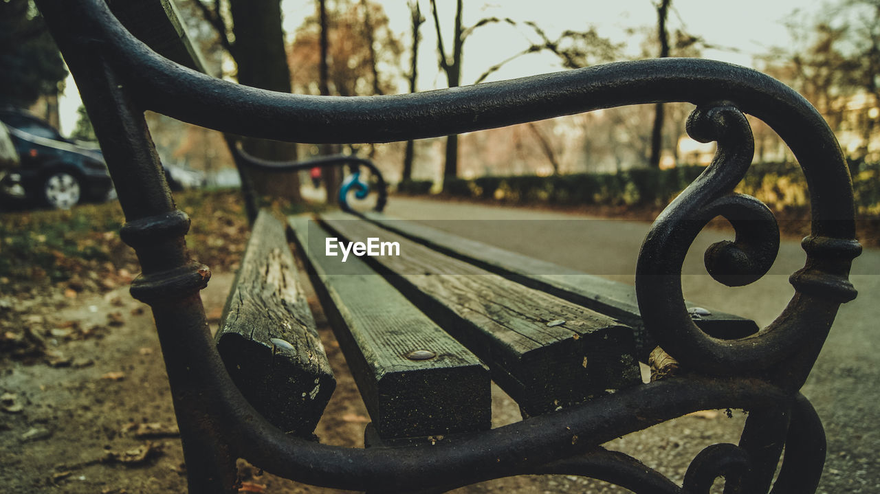 Close-up of weathered park bench